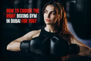 A determined fighter, clad in premium boxing gloves, stands poised with confidence. The banner proudly declares: "Unlock the secrets to selecting the perfect boxing gym for your ultimate journey in Dubai.