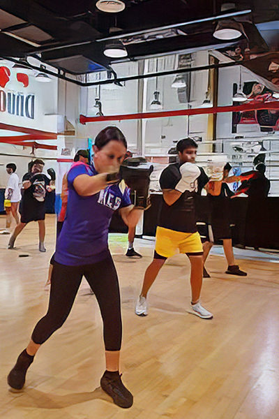 At our distinguished boxing facility in the heart of Dubai, dedicated athletes engage in their craft, clad in premium sports gear. The rhythmic sound of gloves meeting leather echoes through the space as focused individuals refine their skills against an array of state-of-the-art punching bags. Here, every session is a step towards mastery, within an environment crafted for excellence and passion.